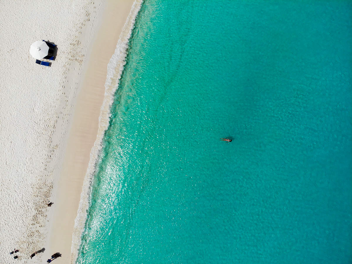 Sonnenschirm aus palmblättern an einem perfekten weißen strand vor